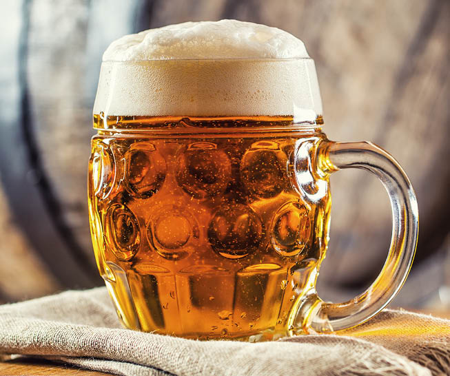 Beer. Two cold beers. Draft beer. Draft ale. Golden beer. Golden ale. Two gold beer with froth on top. Draft cold beer in glass jars in home pub hotel or restaurant. Still life.